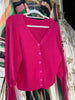Fuchsia vest, met lange manchetten.